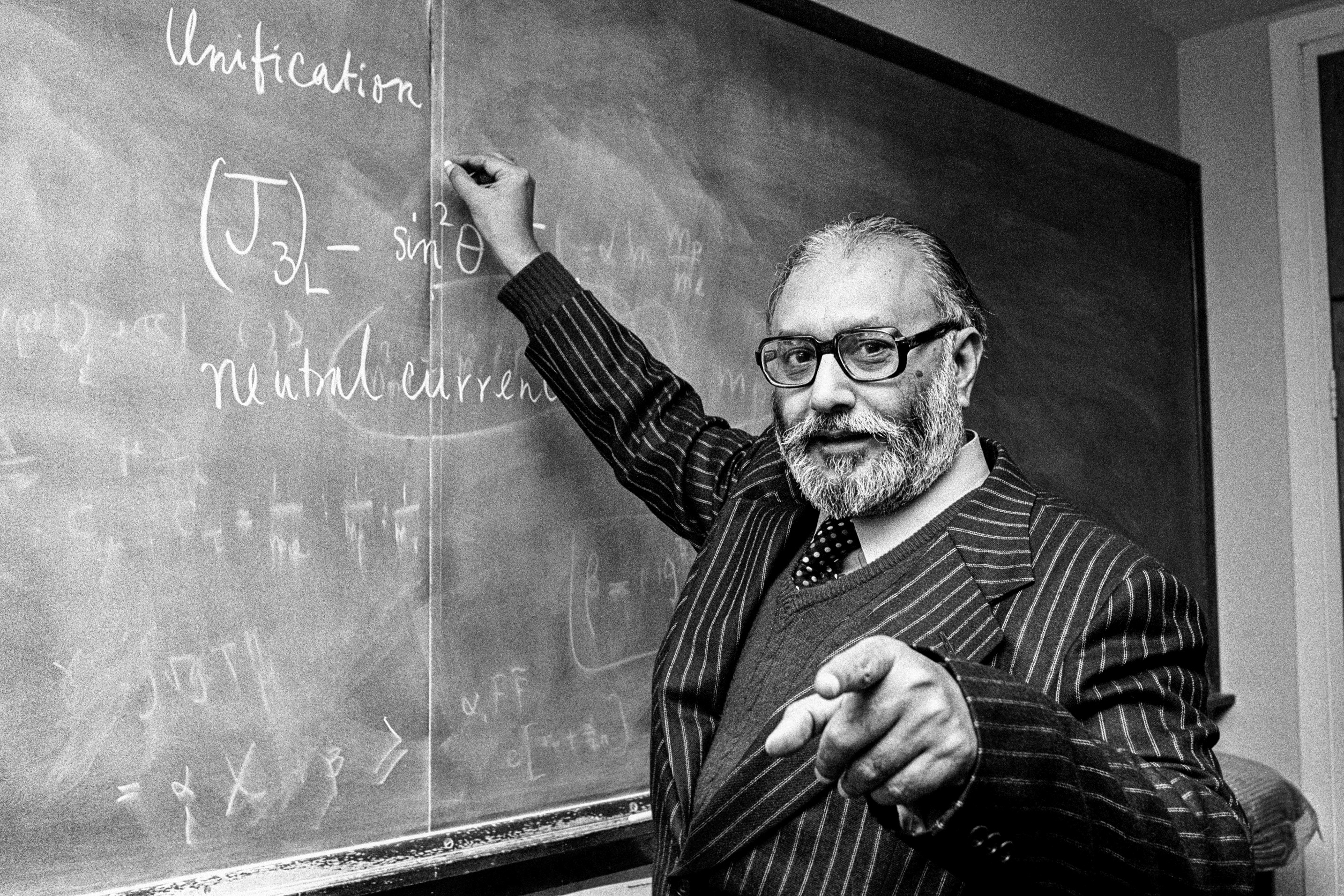 Dr Abdus Salaam in front of a white board